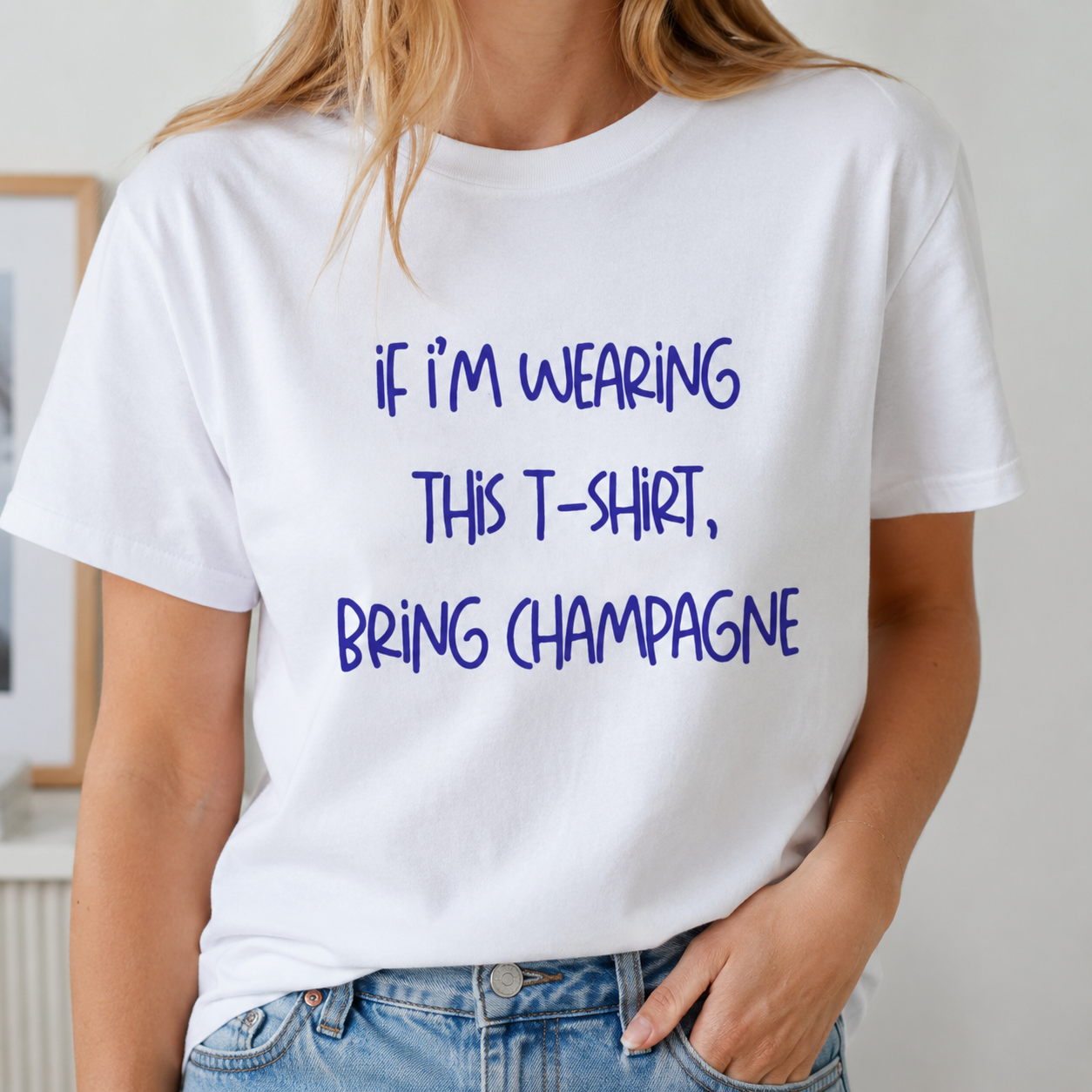 White t-shirt with purple text worn by a person, with a neutral background