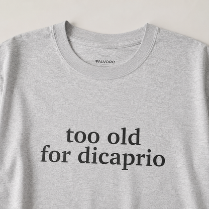 Gray t-shirt with 'too old for dicaprio' text on a light gray background