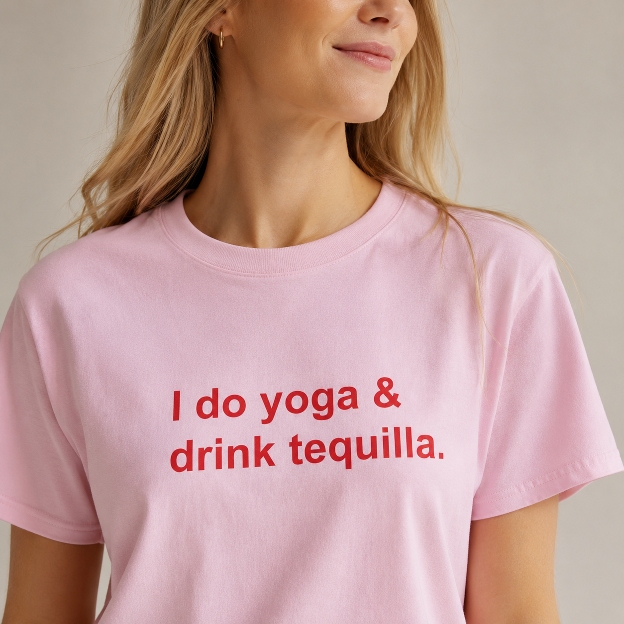 Person wearing a pink t-shirt with red text 'I do yoga & drink tequilla.'